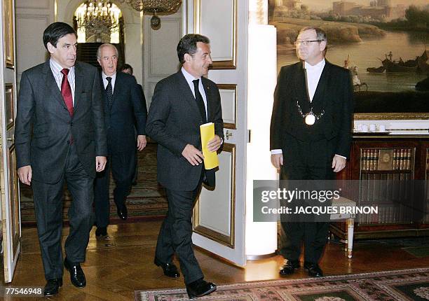 French President Nicolas Sarkozy arrives followed by Prime Minister Francois Fillon and former Prime Minister Edouard Balladur for a meeting with...