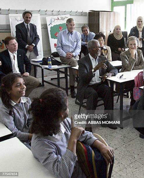 Members of the UN foundation delegation headed by former UN secretary-general Kofi Annan visit a classroom at a school in the Qalandia Palestinian...