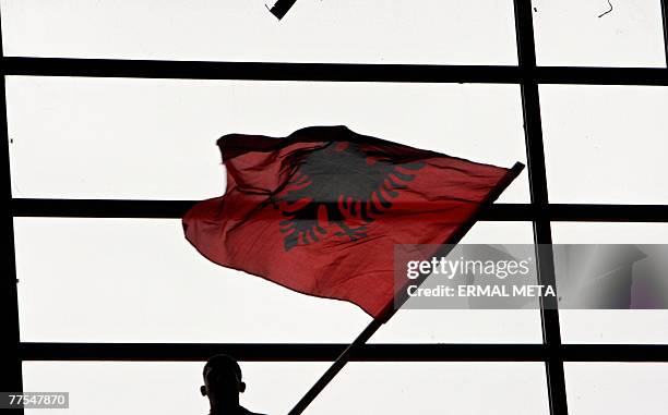 Supporter of the Democratic Party of Kosovo waves an Albanian flag during a PDK electoral rally in Pristina, 29 October 2007. General elections are...