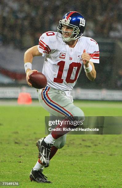 Giants Quarterback Eli Manning scrambles during the NFL Bridgestone International Series match between New York Giants and Miami Dolphins at Wembley...