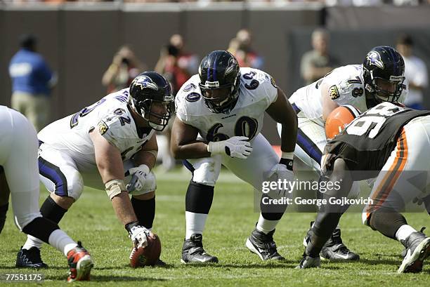 Center Mike Flynn and guard Jason Brown of the Baltimore Ravens confer before the start of a play during a game against the Cleveland Browns at...
