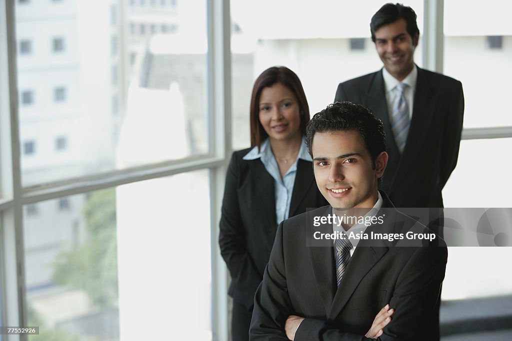 Businesspeople looking at camera, smiling
