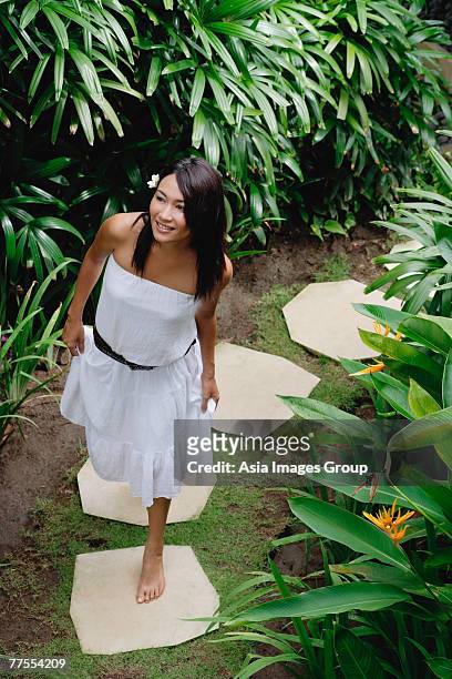 young woman walking in tropical garden - stepping stone top view stock pictures, royalty-free photos & images