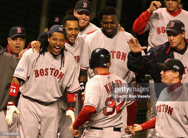 Bobby Kielty of the Boston Red Sox celebrates with teammates David Ortiz and Manny Ramirez after hitting a solo home run against the Colorado Rockies...