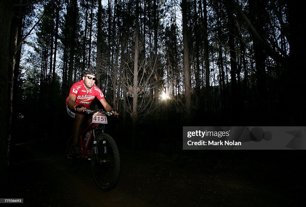 Nolan Stringer A rider makes his way through the forest at sun set during the Mont ...