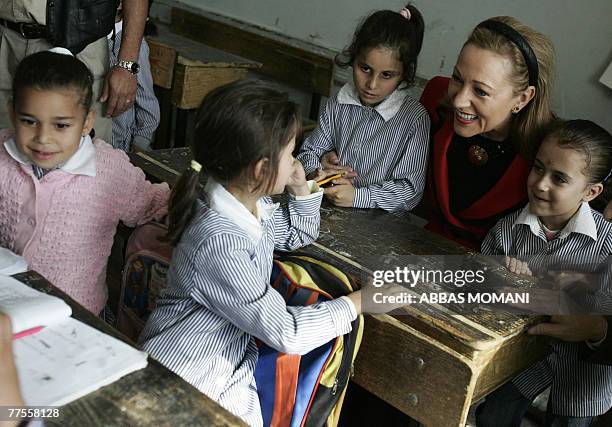 External Relations EU Commissioner Benita Ferrero-Waldner smiles as she sits with school girls at a school in the Qalandia Palestinian refugee camp...