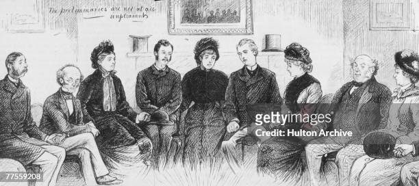 Group of people prepare to hold a seance in an attempt to make contact with the dead, circa 1880. Original Publication : Graphic Magazine.