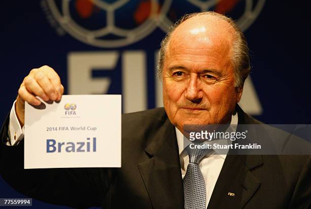 Sepp Blatter, President of FIFA holds the paper announcing Brazil as the host venue of the FIFA Mens World Cup 2014, at the FIFA headquarters on...