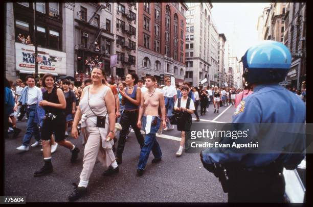 Women march down a street at the Third Annual Lesbian Pride Parade June 24, 1995 in New York City. The parade commemorates the Stonewall riots of...