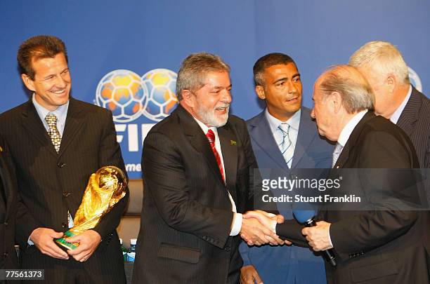 President Sepp Batter shakes hands with Brazilian President Luiz Inacio Lula da Silva whilst being watched by Brazilian National Football Coach Dunga...