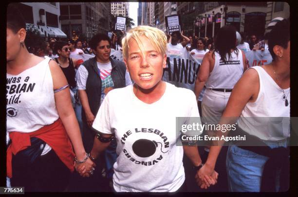 Woman walks while holding hands at the Third Annual Lesbian Pride Parade June 24, 1995 in New York City. The parade commemorates the Stonewall riots...