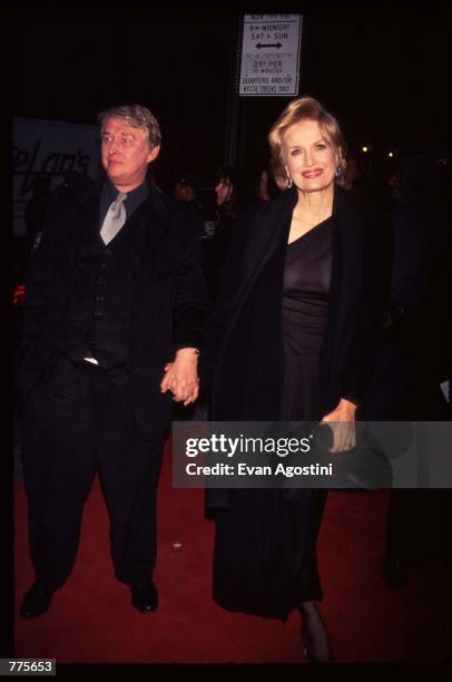 Director Mike Nichols holds hands with his wife, reporter Diane Sawyer, at the premiere of the film "The Birdcage" March 3, 1996 in New York City....