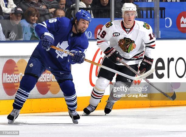 Darcy Tucker of the Toronto Maple Leafs skates up ice with Jonathan Toews of the Chicago Blackhawks October 20, 2007 at the Air Canada Centre in...