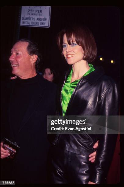Actress Sigourney Weaver stands with her husband Jim Simpson at the premiere of the film "The Birdcage" March 3, 1996 in New York City. The movie,...