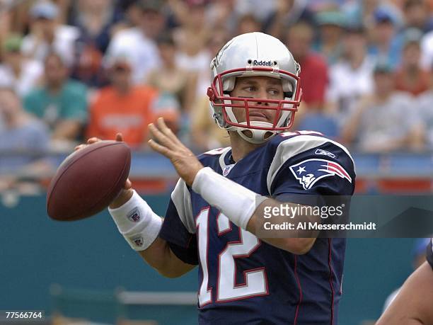Quarterback Tom Brady of the New England Patriots sets to pass against the Miami Dolphins at Dolphin Stadium on October 21, 2007 in Miami, Florida....