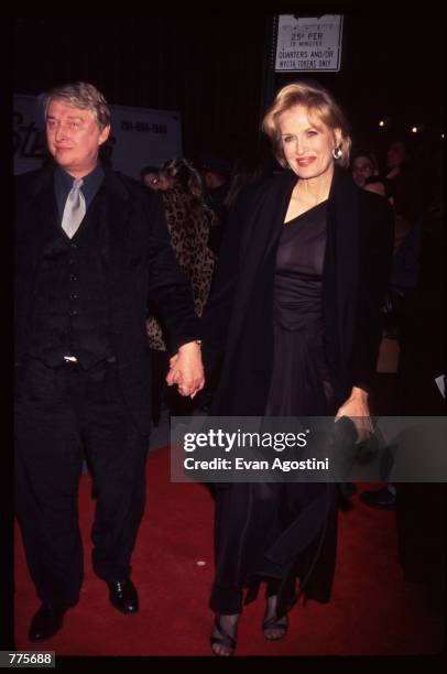 Director Mike Nichols holds hands with his wife, reporter Diane Sawyer, at the premiere of the film "The Birdcage" March 3, 1996 in New York City....