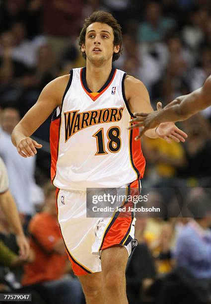 Marco Belinelli of the Golden State Warriors celebrates after hitting a three-pointer against the Utah Jazz during their NBA season opener October...