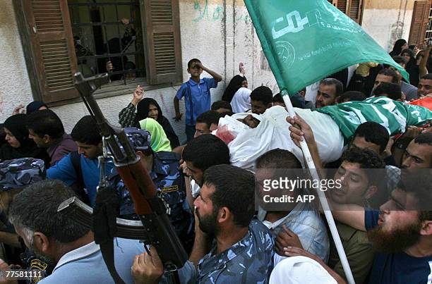Palestinian mourn carry the body of Maher Abu Taer one of four fighters killed during an Israeli raid from Hamas' armed wing, the Ezzedine al-Qassam...