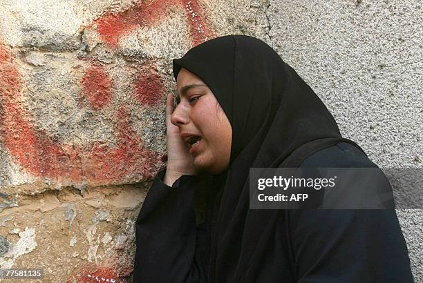 Palestinian mourner weeps during the funeral of Maher Abu Taer one of four fighters killed from Hamas' armed wing, the Ezzedine al-Qassam Brigades,...