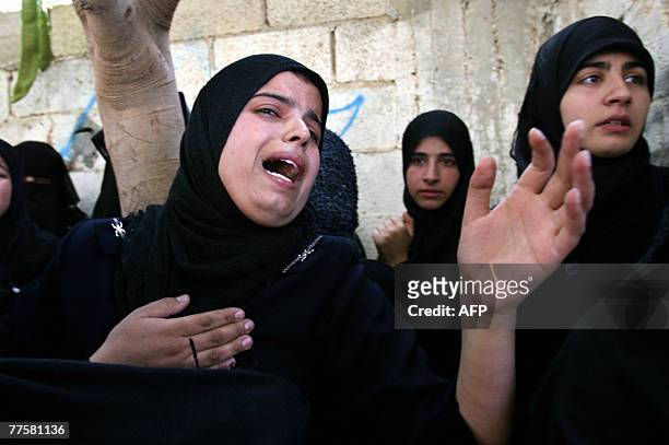 Palestinian mourners weep during the funeral of Maher Abu Taer one of four fighters killed from Hamas' armed wing, the Ezzedine al-Qassam Brigades,...