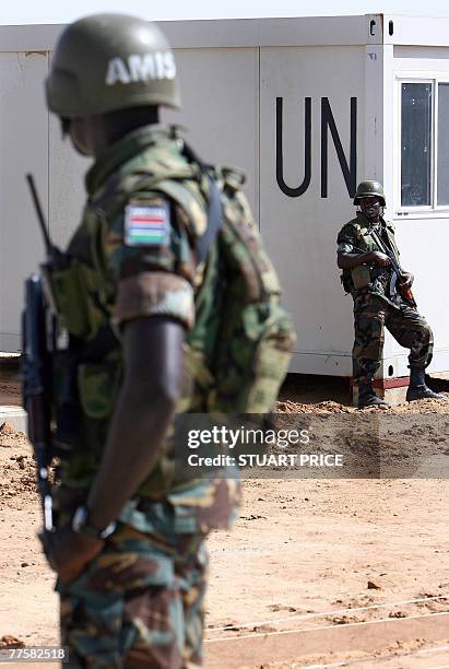 African Union Mission in the Sudan peacekeepers stand guard during a visit by the UN-AU joint special representative for Darfur, Roldophe Adada,...