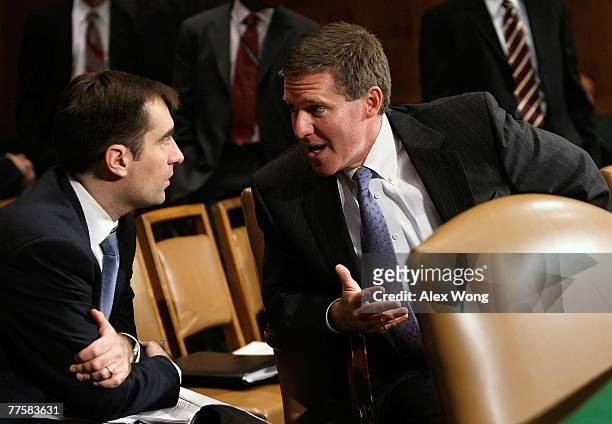 Assistant Attorney General Kenneth Wainstein of the National Security Division at U.S. Justice Department talks to an unidentified aide prior to a...