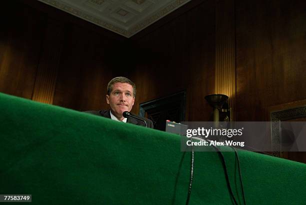 Assistant Attorney General Kenneth Wainstein of the National Security Division at U.S. Justice Department pauses as he testifies during a hearing...
