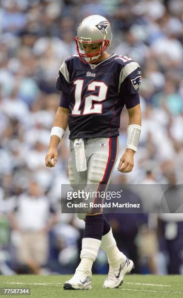 Quarterback Tom Brady of the New England Patriots walks on the field during the game against the Dallas Cowboys at Texas Stadium on October 14, 2007...