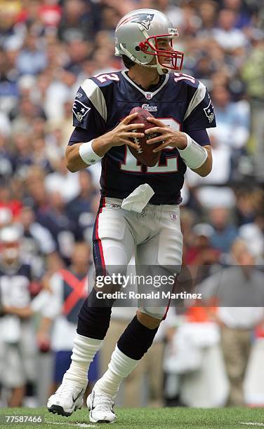 Quarterback Tom Brady of the New England Patriots looks to pass the ball during the game against the Dallas Cowboys at Texas Stadium on October 14,...