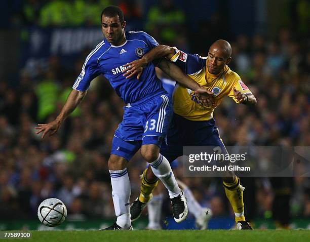 Alex of Chelsea holds off James Chambers of Leicester City during the Carling Cup Fourth Round match between Chelsea and Leicester City at Stamford...