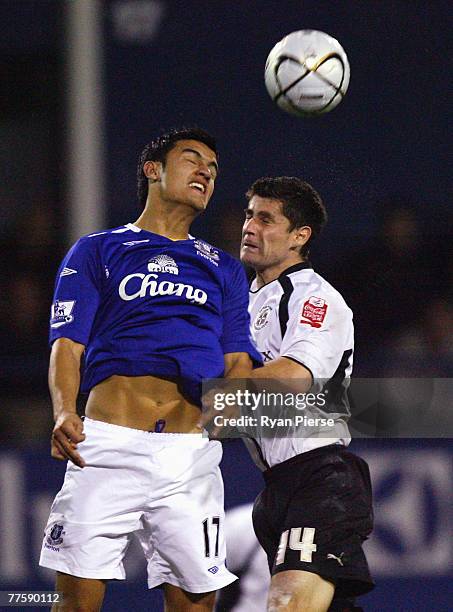 Tim Cahill of Everton competes for the ball against Steve Robinson of Luton Town during the Carling Cup Fourth Round match between Luton Town and...