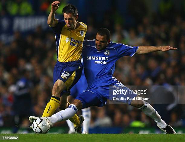 Alex of Chelsea tackles Matty Fryatt of Leicester City during the Carling Cup Fourth Round match between Chelsea and Leicester City at Stamford...