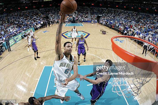 Tyson Chandler of the New Orleans Hornets shoots over Brad Miller of the Sacramento Kings on October 31, 2007 at the New Orleans Arena in New...