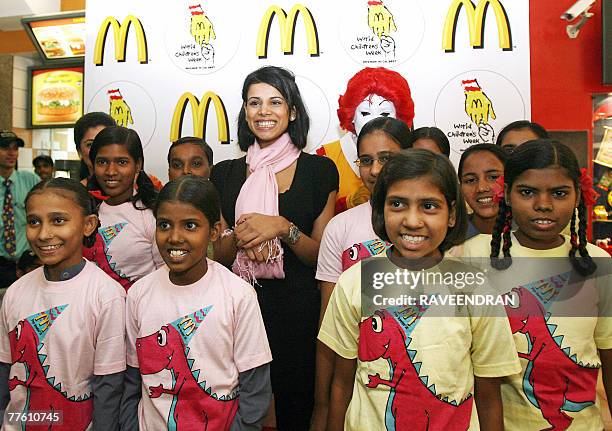 Indian TV actress Neha Kapoor poses with childrens from Dr. Shroff's Charity Eye Hospital during the World Children's Week 2007 in New Delhi, 01...