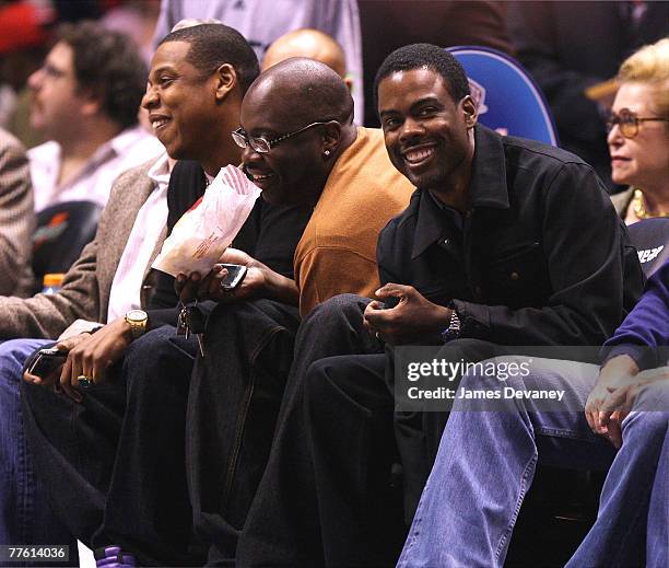 Jay-Z, guest and Chris Rock attend the Chicago Bulls vs New Jersey Nets game at the IZOD Center on October 31, 2007 in East Rutherford, New York.