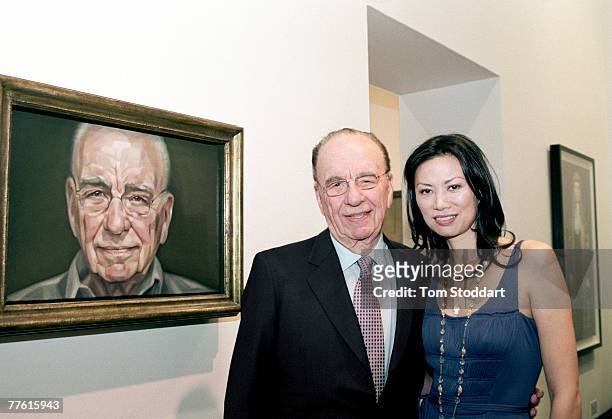 News Corporation Chairman and CEO Rupert Murdoch and his wife Wendi photographed in front of his portrait which was painted by British artist...