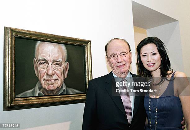 News Corporation Chairman and CEO Rupert Murdoch and his wife Wendi photographed in front of his portrait which was painted by British artist...