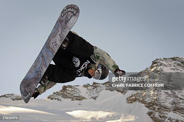 Finland's Janne Korpi is airborn over the Swiss Alps during the Mens' half-pipe qualification run at the Snowboard FIS World Cup competition 01...