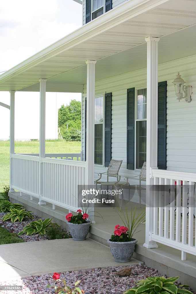 Front Porch Of Multistory House With White Siding High-Res Stock Photo ...