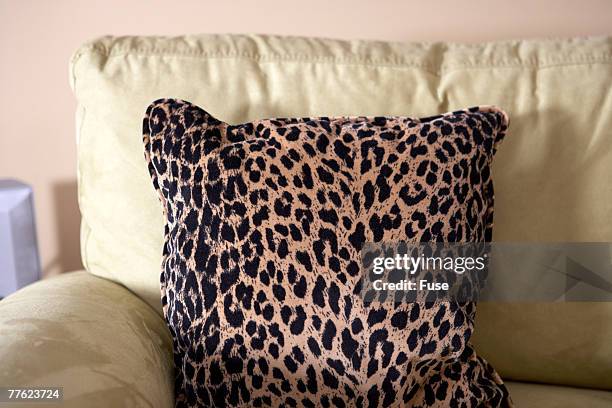 leopard print throw pillow on armchair - leopard print stock pictures, royalty-free photos & images