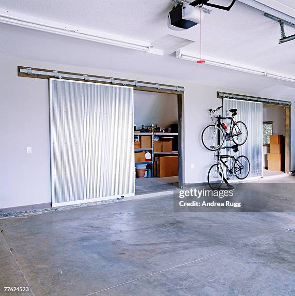 two bicycles kept in a spacious and tidy garage - bottles of meta stock pictures, royalty-free photos & images