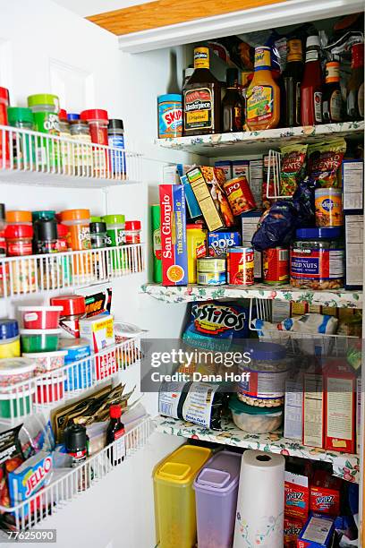 full white pantry with wire baskets and floral shelves - stacked canned food stock pictures, royalty-free photos & images