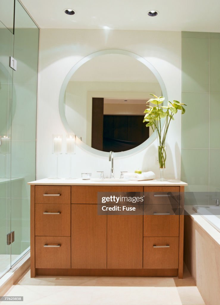Round Wall Mirror over Sink in Contemporary Bathroom