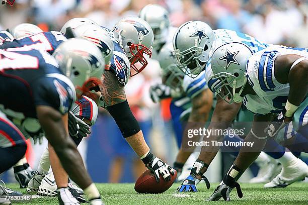 The New England Patriots offensive line squares off with the Dallas Cowboys defensive line in a game at Texas Stadium on October 14, 2007 in Irving,...