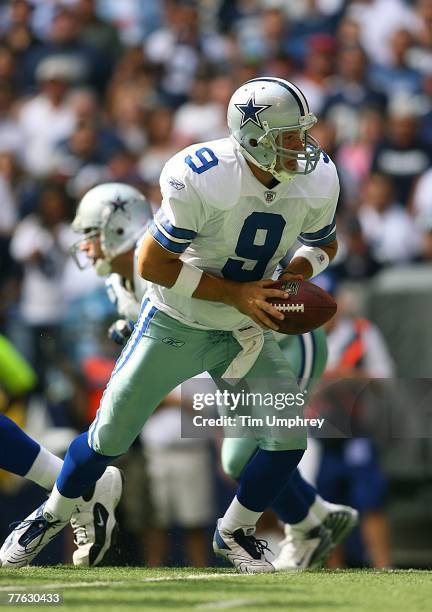 Quarterback Tony Romo of the Dallas Cowboys hands off to the running back in a game against the New England Patriots at Texas Stadium on October 14,...