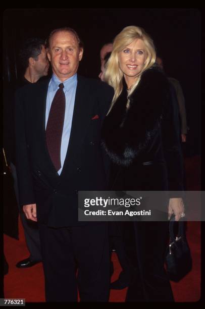 Producer Michael Medavoy stands with a date stands at the premiere of the film "The Mirror Has Two Faces" November 10, 1996 in New York City. The...