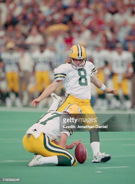 Ryan Longwell, Kicker for the Green Bay Packers prepares to kick for goal as Craig Hentrich holds the ball during the National Football Conference...