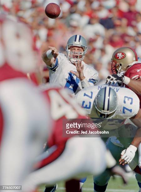 Troy Aikman, Quarterback for the Dallas Cowboys throws the ball downfield during the National Football Conference West game against the San Francisco...