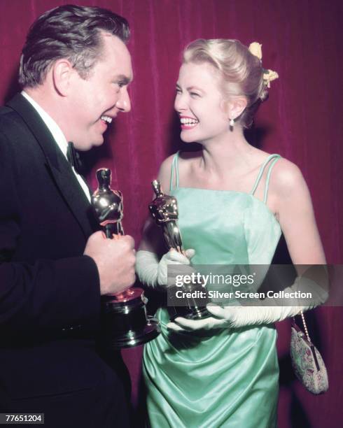 American actors Edmond O'Brien and Grace Kelly celebrate their wins at the Academy Awards in Los Angeles, 30th March 1955. O'Brien won Best...