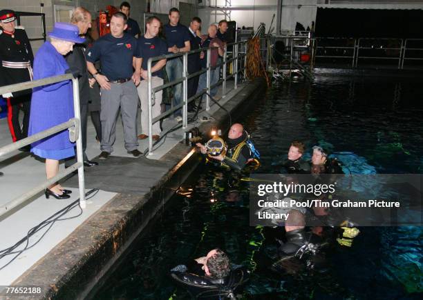Queen Elizabeth II and Prince Philip, Duke of Edinburgh meet divers working on the underwater stage at Pinewood Studios on November 2, 2007 in...